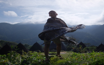 Wae Rebo Village in Flores surrounded by misty green mountains, showcasing traditional Mbaru Niang houses, wae rebo village flores eco tour